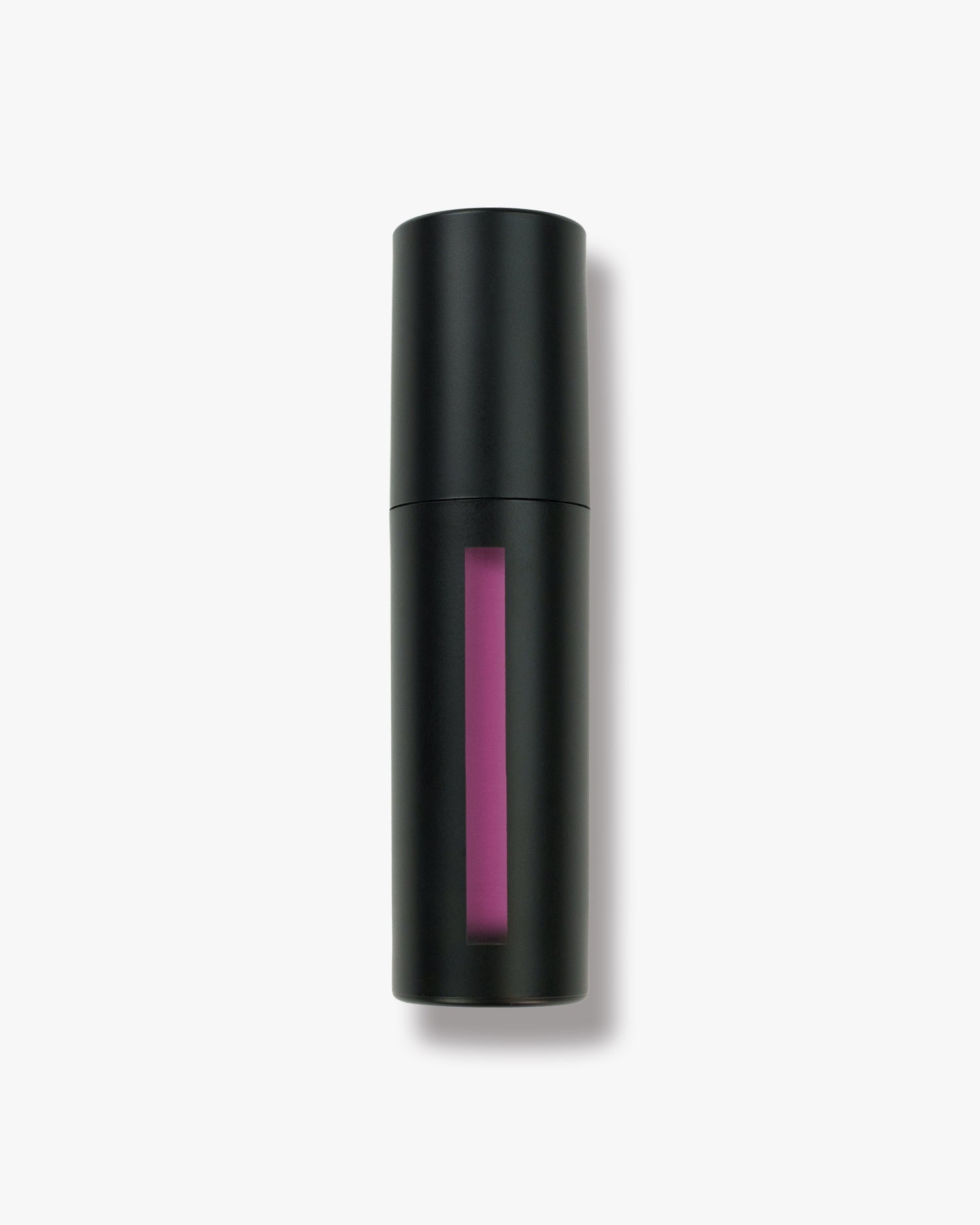 Seint Lip Tint in Pinky, its black cylinder bottle revealing a vivid magenta-pink tint through the window