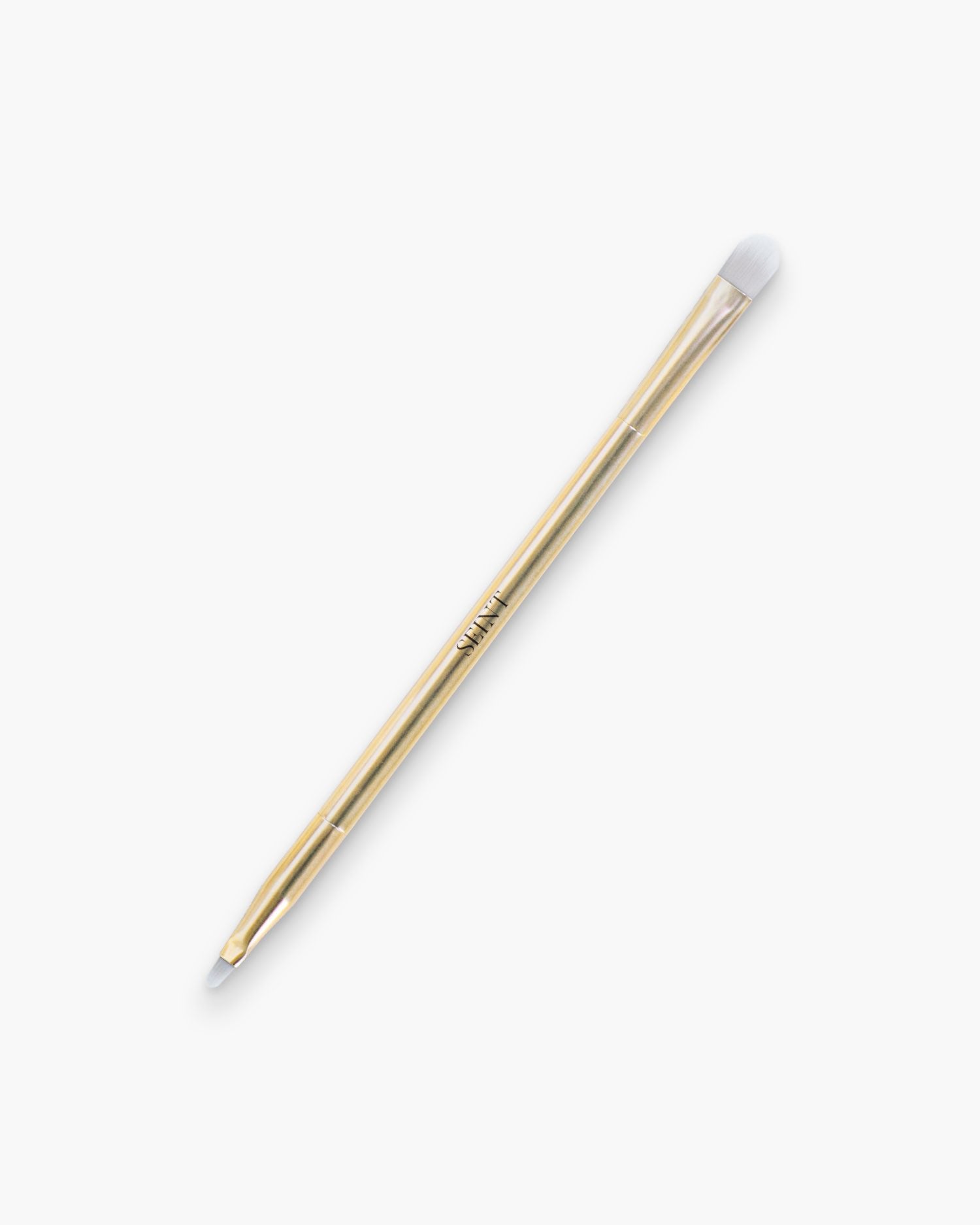 Seint Multitasker Brush in gold — slim double-ended brush with a rounded shading tip and a fine detail end