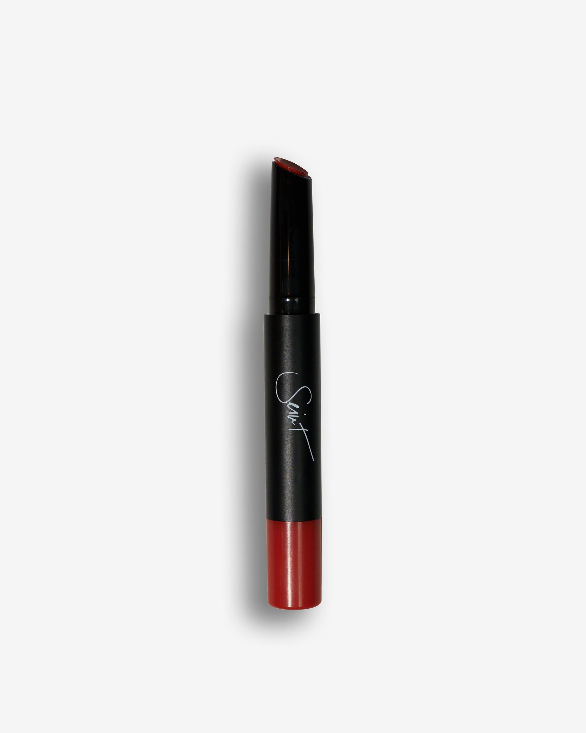 Seint Lip Gelato in Pomegranate, its slanted tip and base a deep brick-red cream
