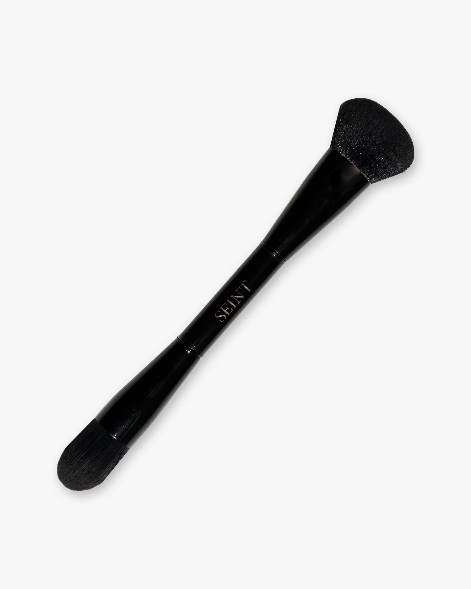 Seint Pilot Brush in glossy black with a full angled powder head on one end and a smaller tapered head on the other