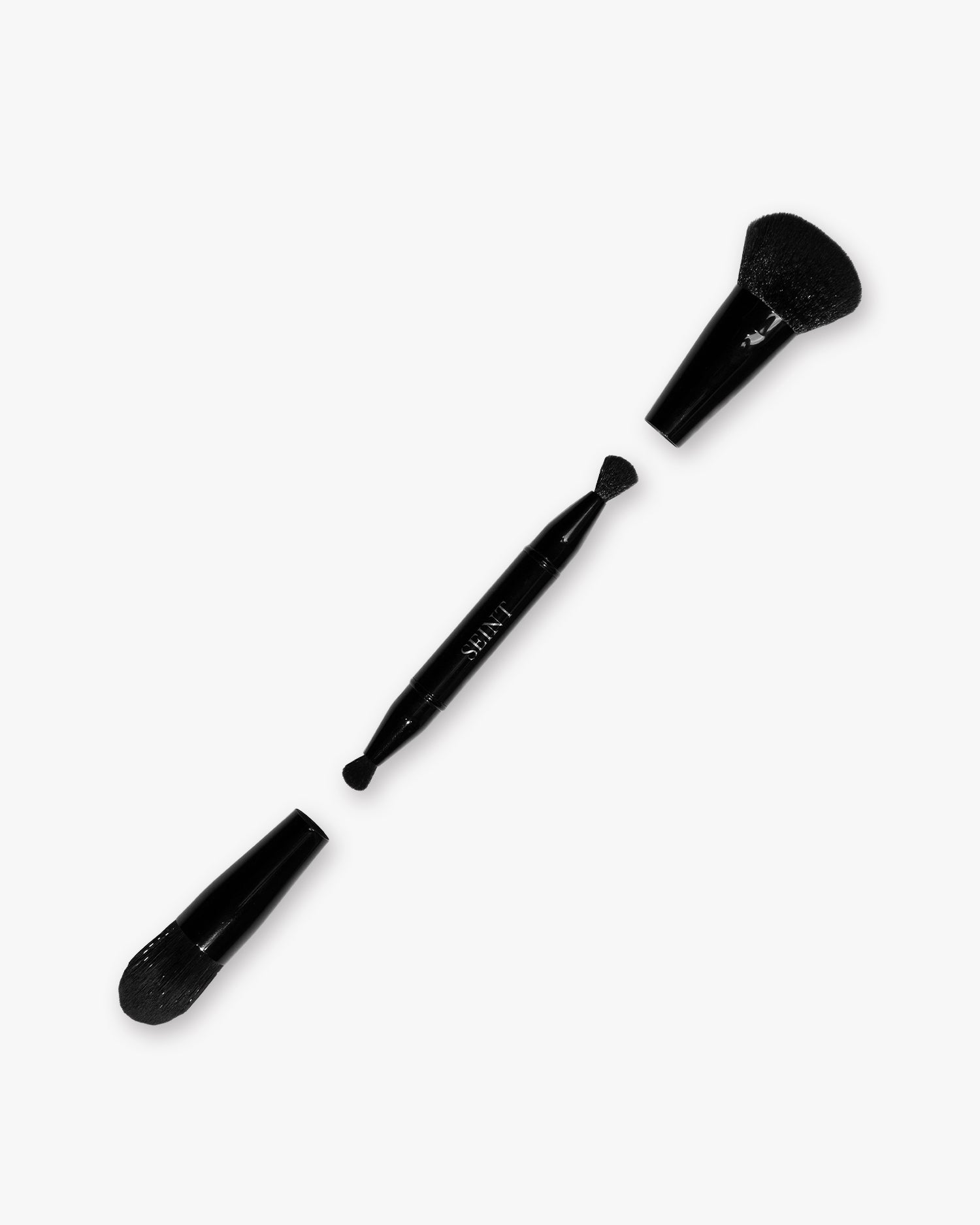 Seint Pilot Brush taken apart — black handle with two small dome tips beside its two larger snap-on brush heads