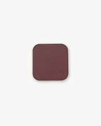 Seint Pressed Pigment in Baker Street, a deep plum-brown matte powder in a square silver tin