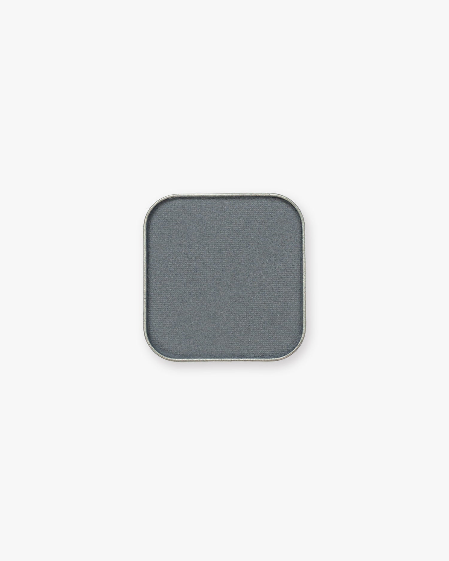 Seint Pressed Pigment in Blue Suede, a muted slate blue-gray powder in a silver-edged pan