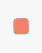 Seint Pressed Pigment in Coral, a warm peachy-coral matte powder in its metal pan