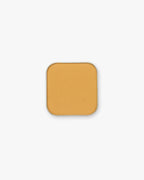 Seint Pressed Pigment in Daisy, a warm honey-gold matte powder in a rounded square tin