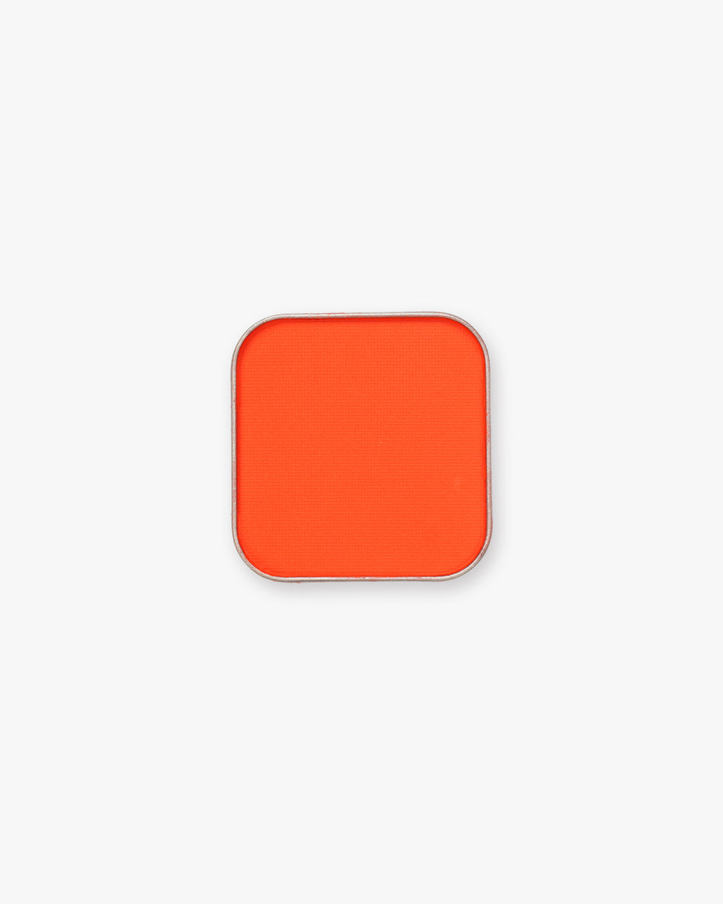 Seint Pressed Pigment in Daze, a vivid red-orange matte powder in a square silver tin