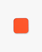 Seint Pressed Pigment in Daze, a vivid red-orange matte powder in a square silver tin