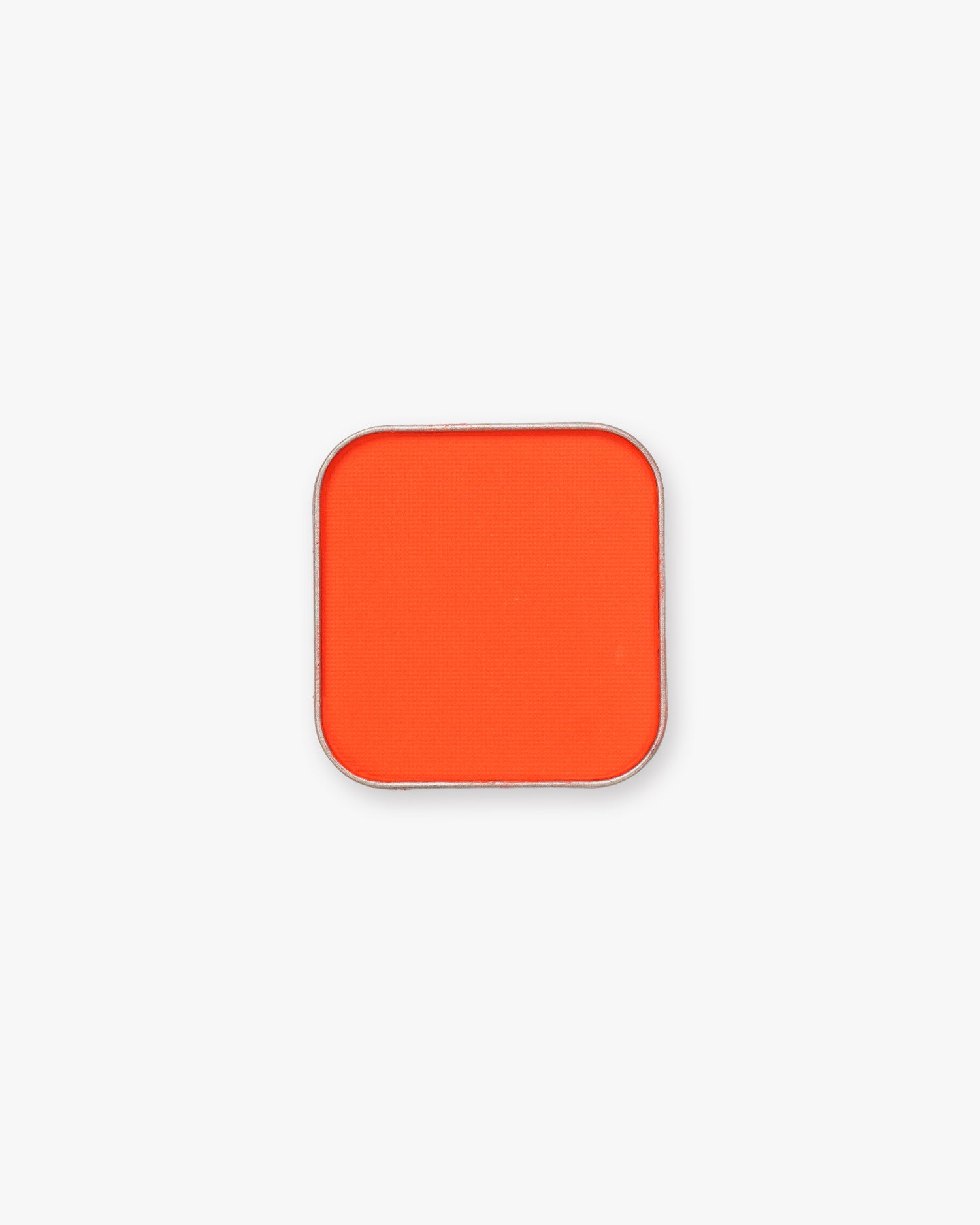 Seint Pressed Pigment in Daze, a vivid red-orange matte powder in a square silver tin