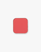 Seint Pressed Pigment in Everly, a punchy coral-red matte powder in a rounded square tin