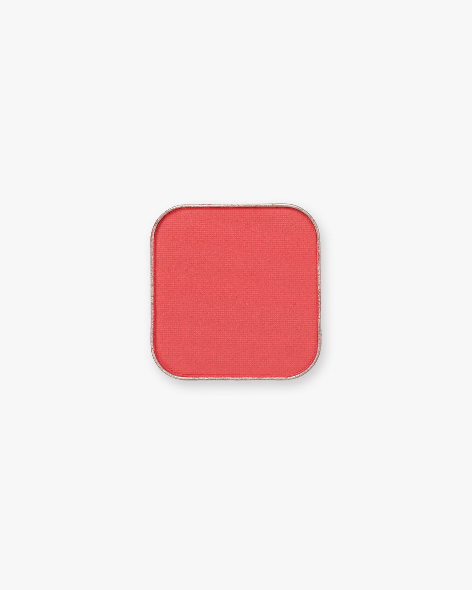 Seint Pressed Pigment in Everly, a punchy coral-red matte powder in a rounded square tin