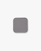 Seint Pressed Pigment in Figaro, a cool stone-gray matte powder in a rounded metal pan