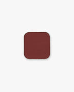 Seint Pressed Pigment in Honeymoon shows a rich brick-red matte powder in a square tin