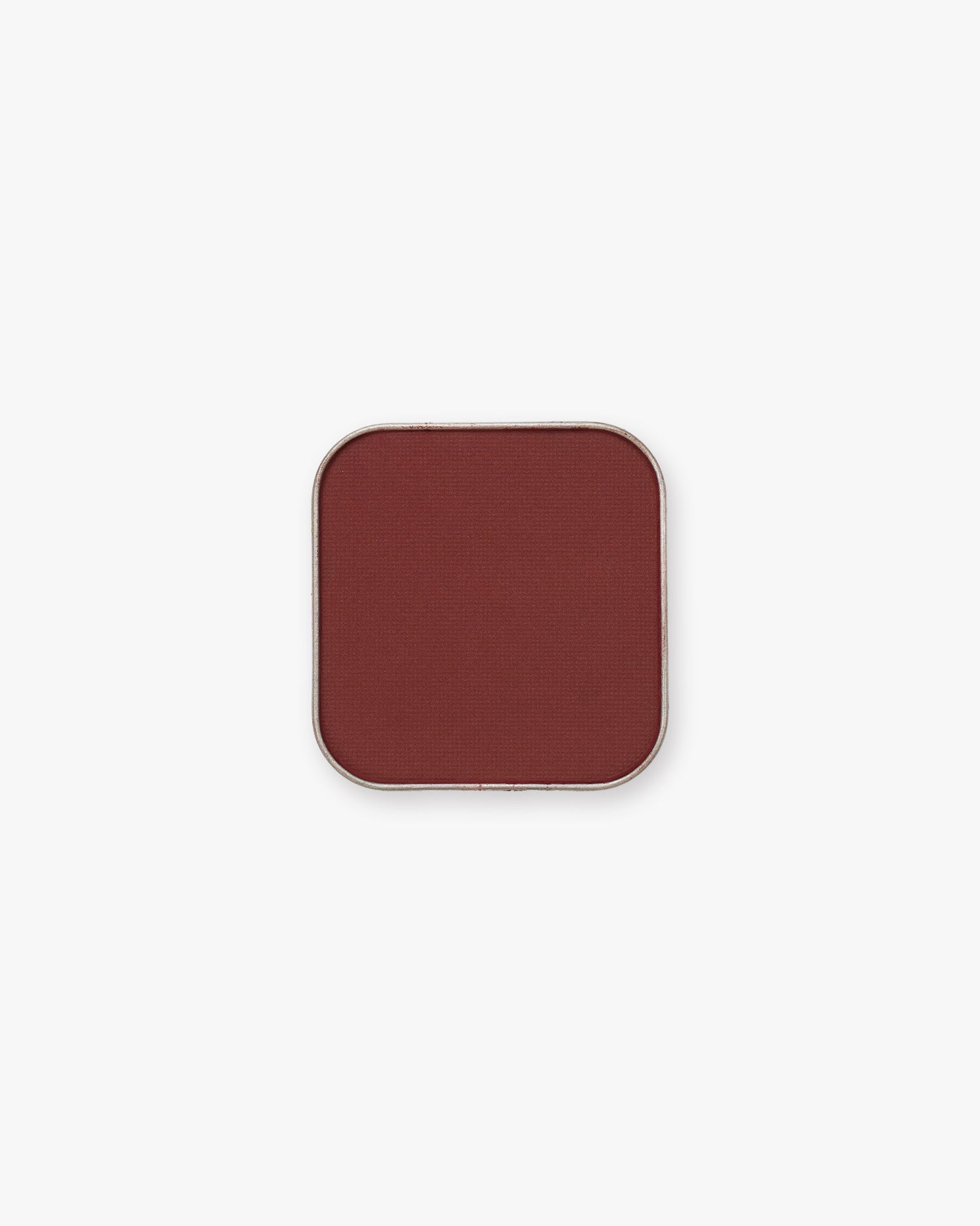 Seint Pressed Pigment in Honeymoon shows a rich brick-red matte powder in a square tin