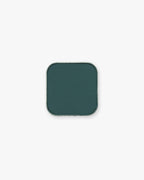 Deep teal-green Seint Pressed Pigment in Juniper, shown in its square metal pan