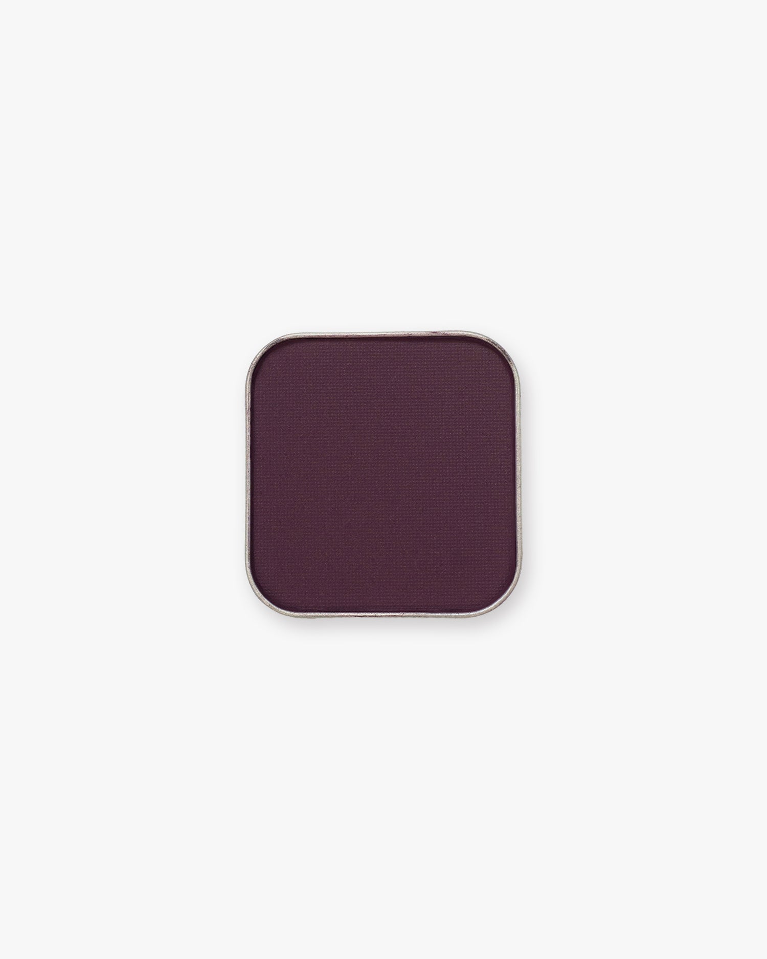 Deep aubergine-plum Seint Pressed Pigment in Lyra shown pressed in its square tin