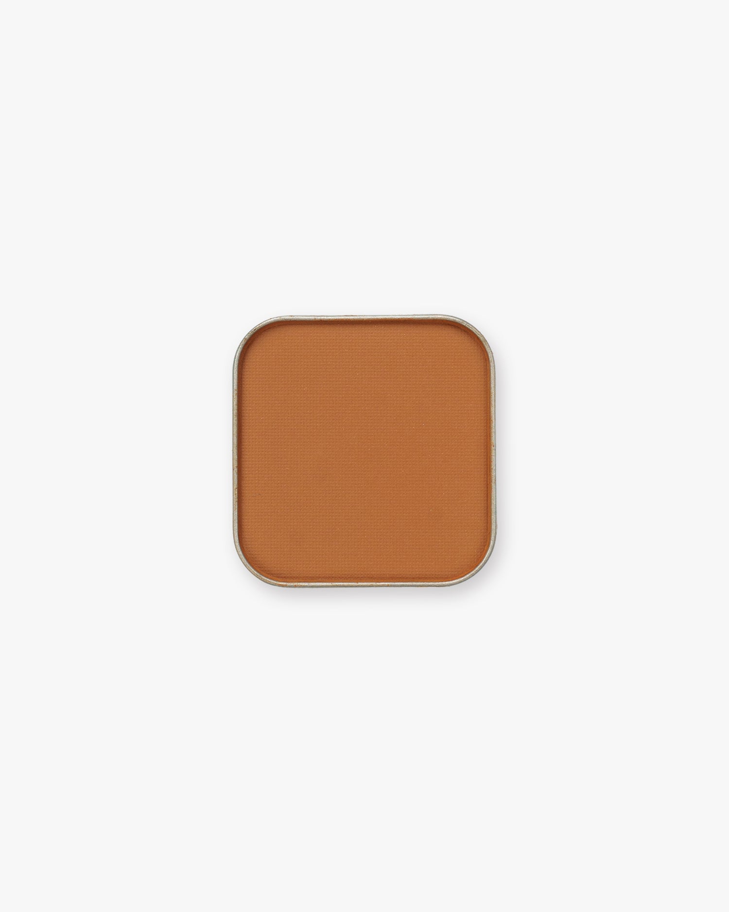 Seint Pressed Pigment in Santa Fe, a warm terracotta matte powder pressed into a silver pan