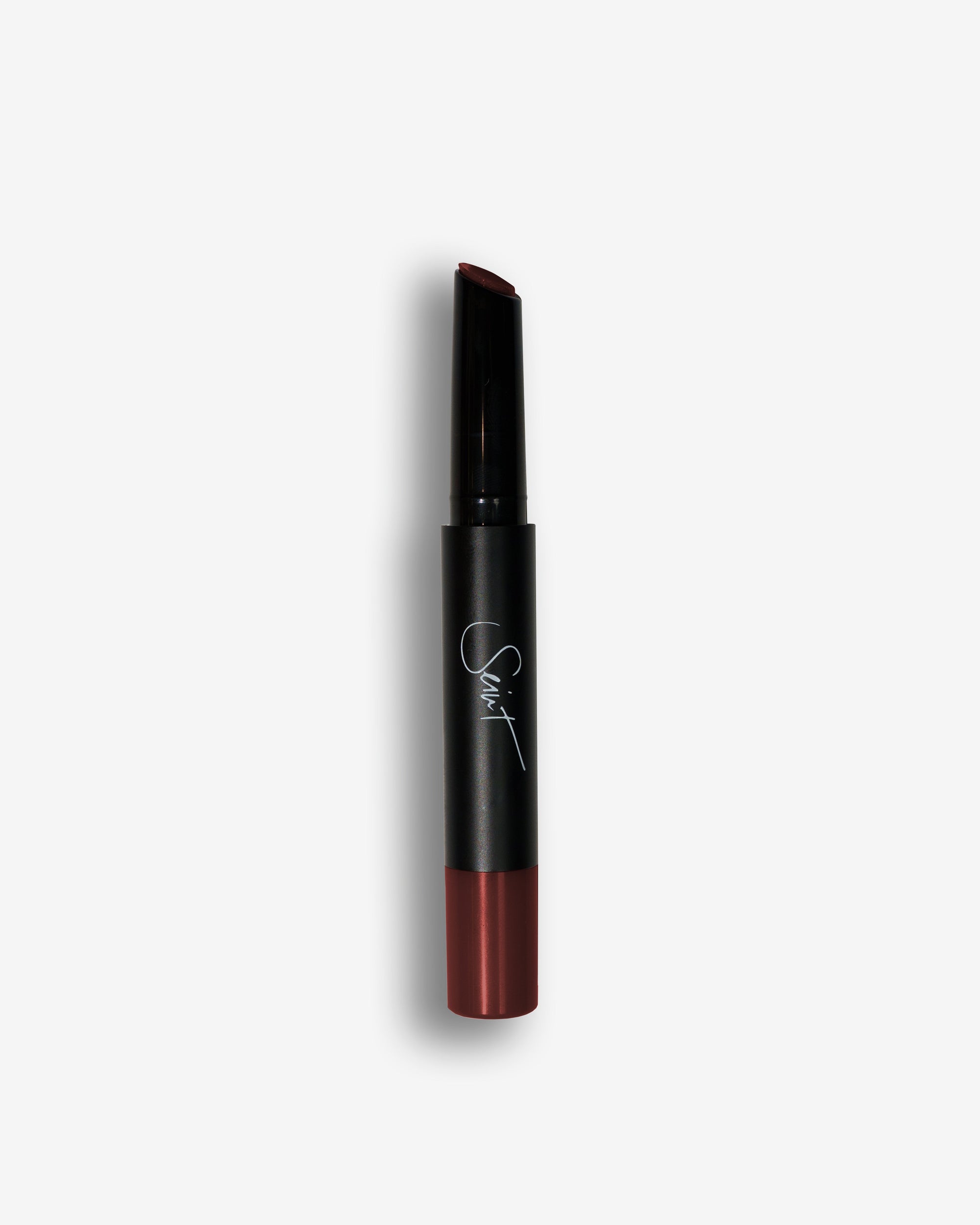 Seint Lip Gelato in Raspberry, black stick showing a deep berry-burgundy cream shade