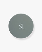 Seint Refresh Wipes matte sage-gray jar lid with the Seint monogram, viewed from directly above