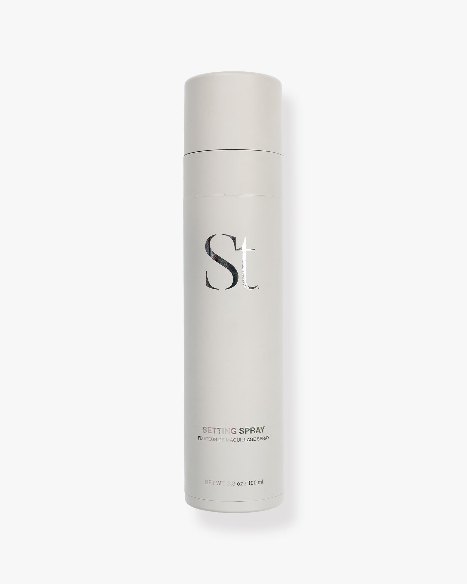 Seint Setting Spray in a tall ivory 3.3 oz canister printed with the brand's serif monogram