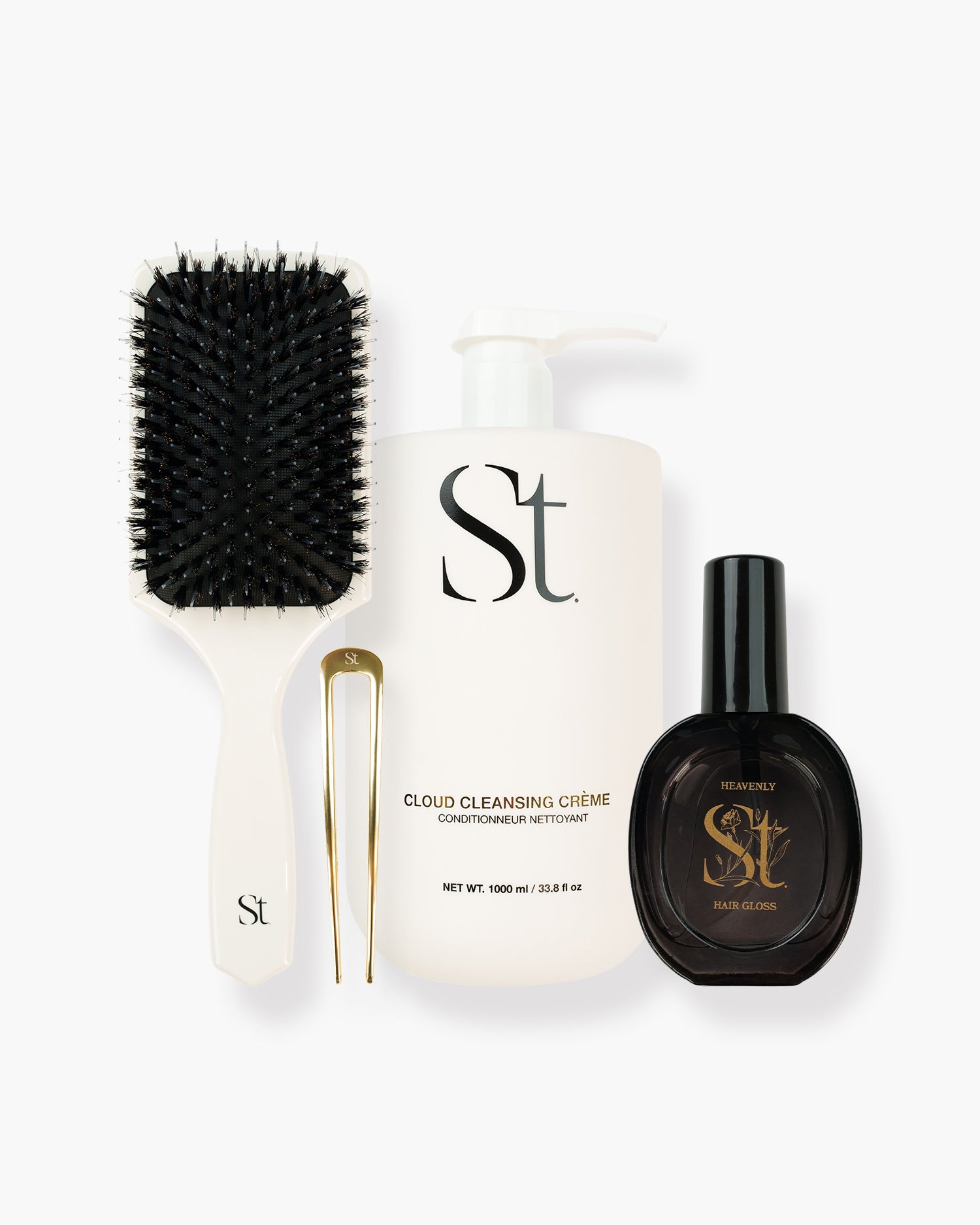 Seint Shine Bundle: white paddle brush, gold hair pin, Cloud Cleansing Crème pump bottle, and Heavenly Hair Gloss