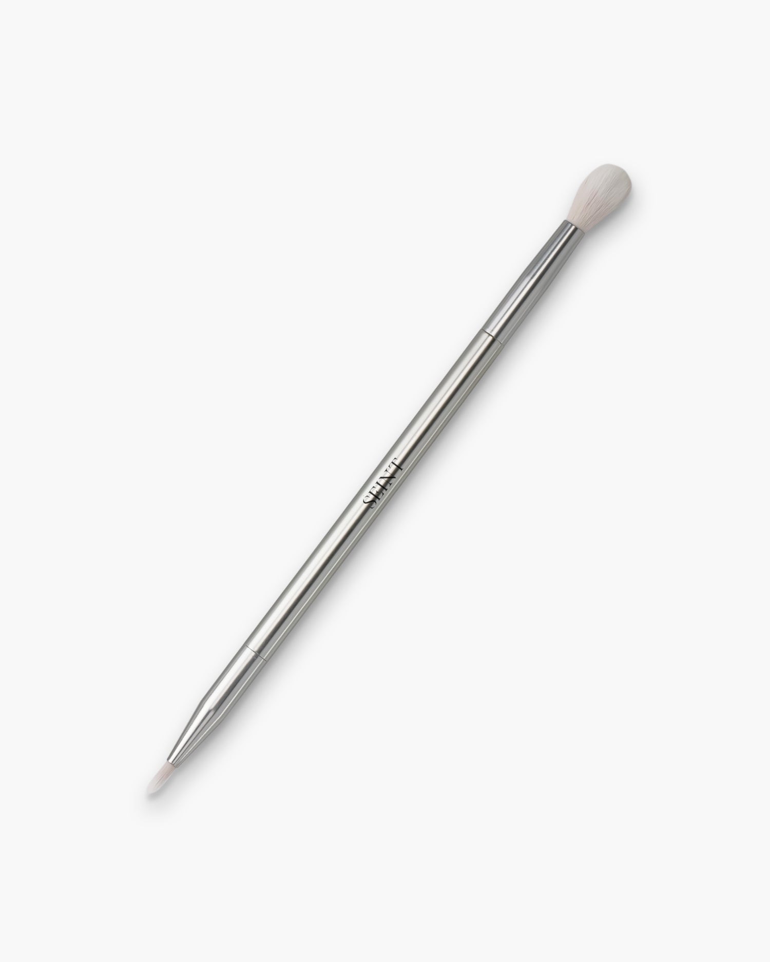 Seint Spot Brush in silver — slim double-ended handle with SEINT wordmark, tapered white bristles and a tiny precision tip