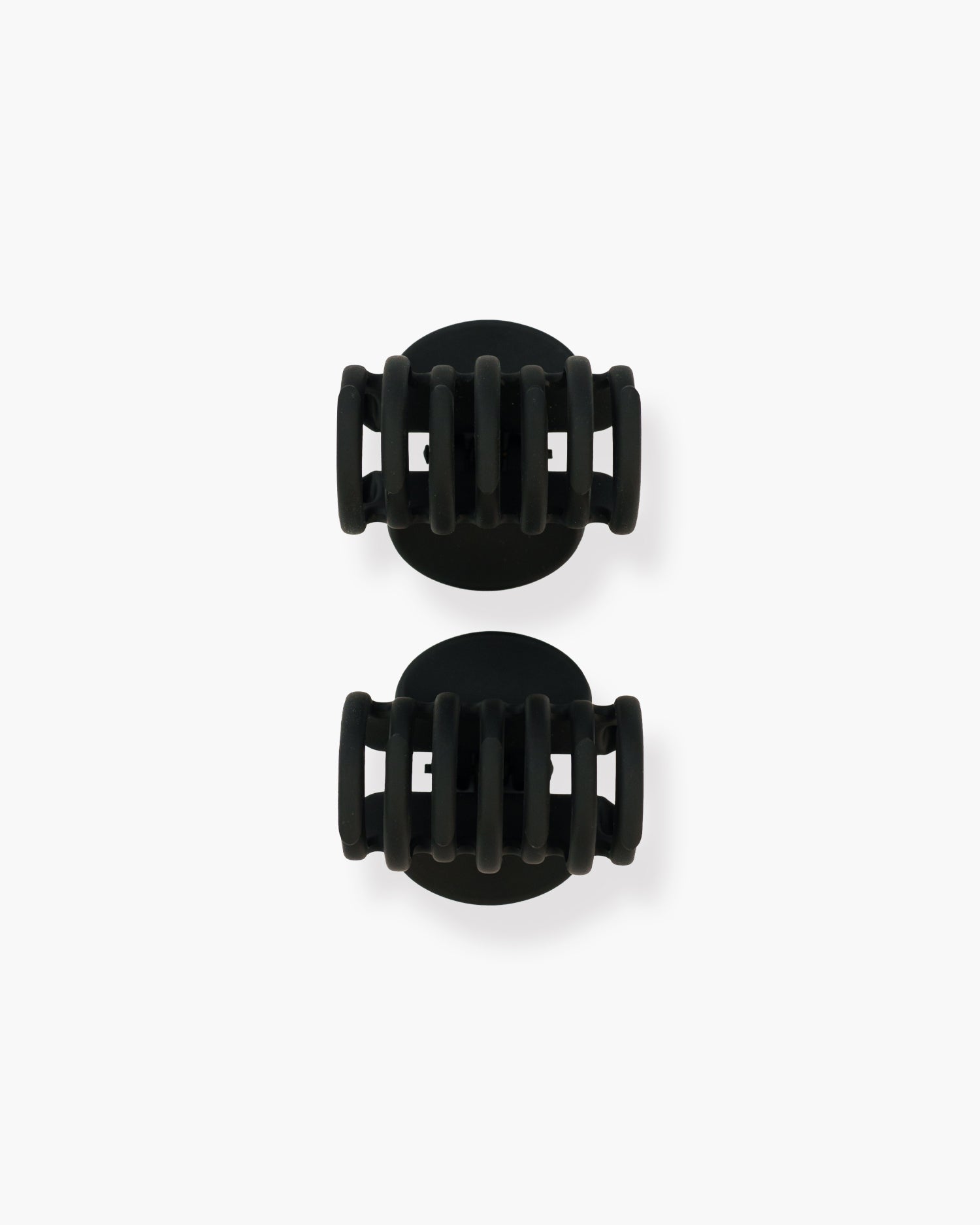 Seint The Hair Clip set of two closed matte black claw clips viewed from above with rounded oval tops