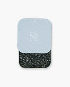 Seint 1/2 Brush Cleaning Tile with its monogrammed gray lid slid back to reveal the black textured sponge
