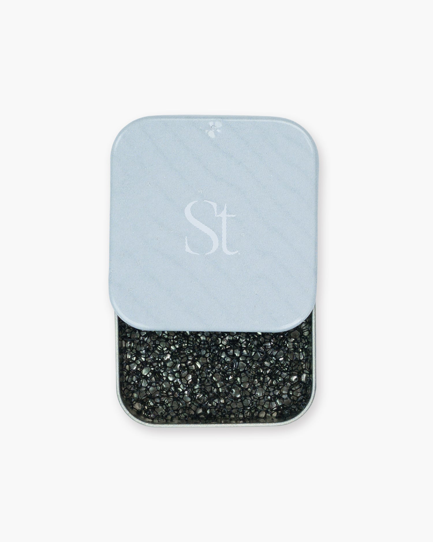 Seint 1/2 Brush Cleaning Tile with its monogrammed gray lid slid back to reveal the black textured sponge