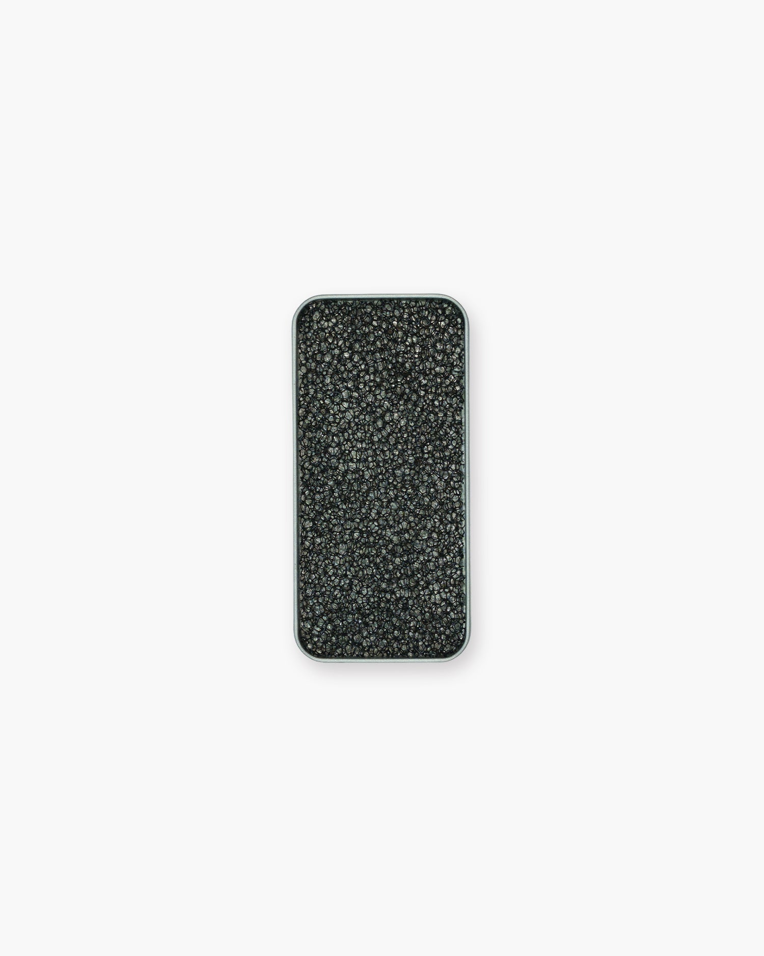 Seint Brush Cleaning Tile from above: a black open-cell sponge texture filling the rectangular silver tin
