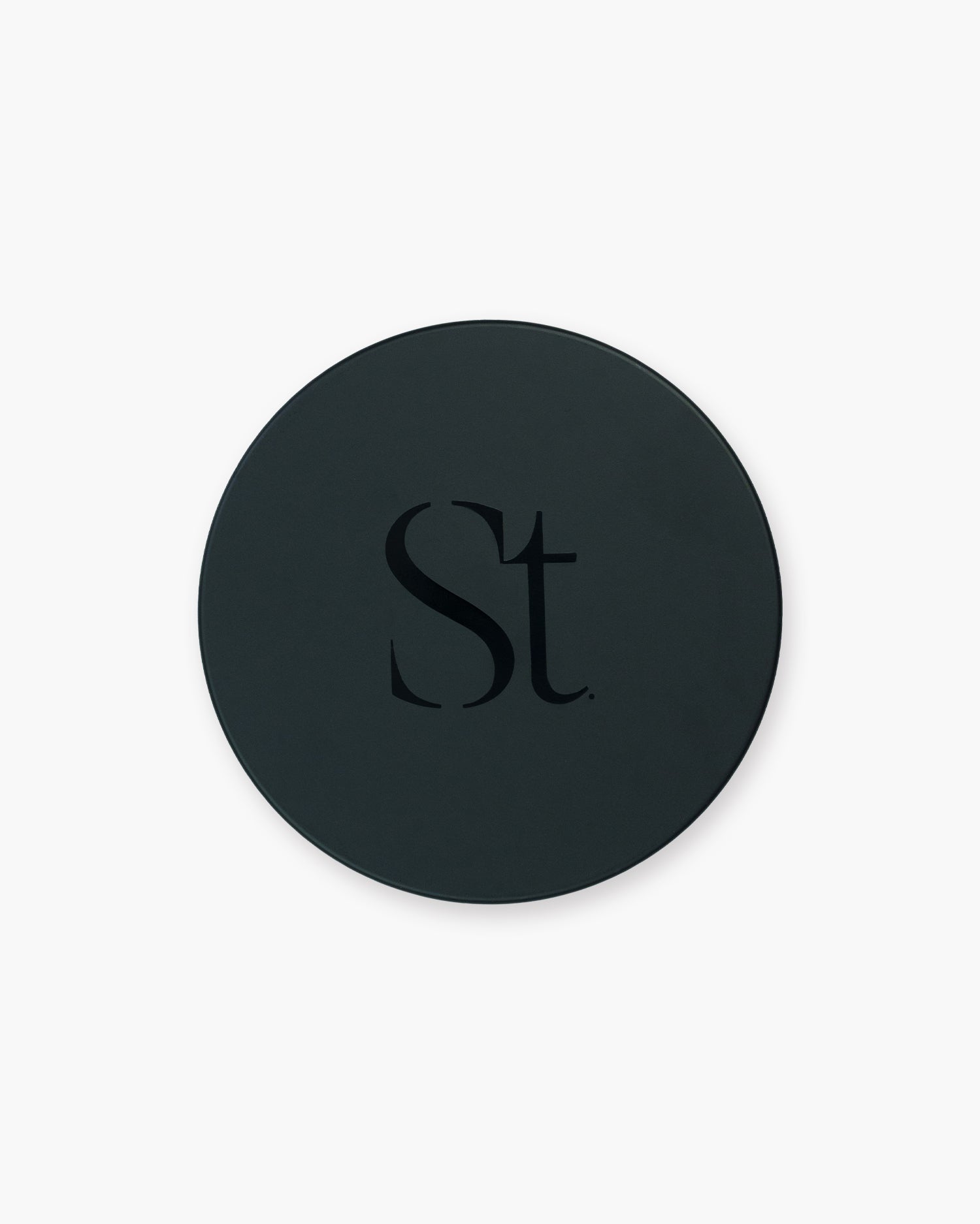 Seint Brush Cleansing Soap round black tin closed, its lid marked with the Seint monogram