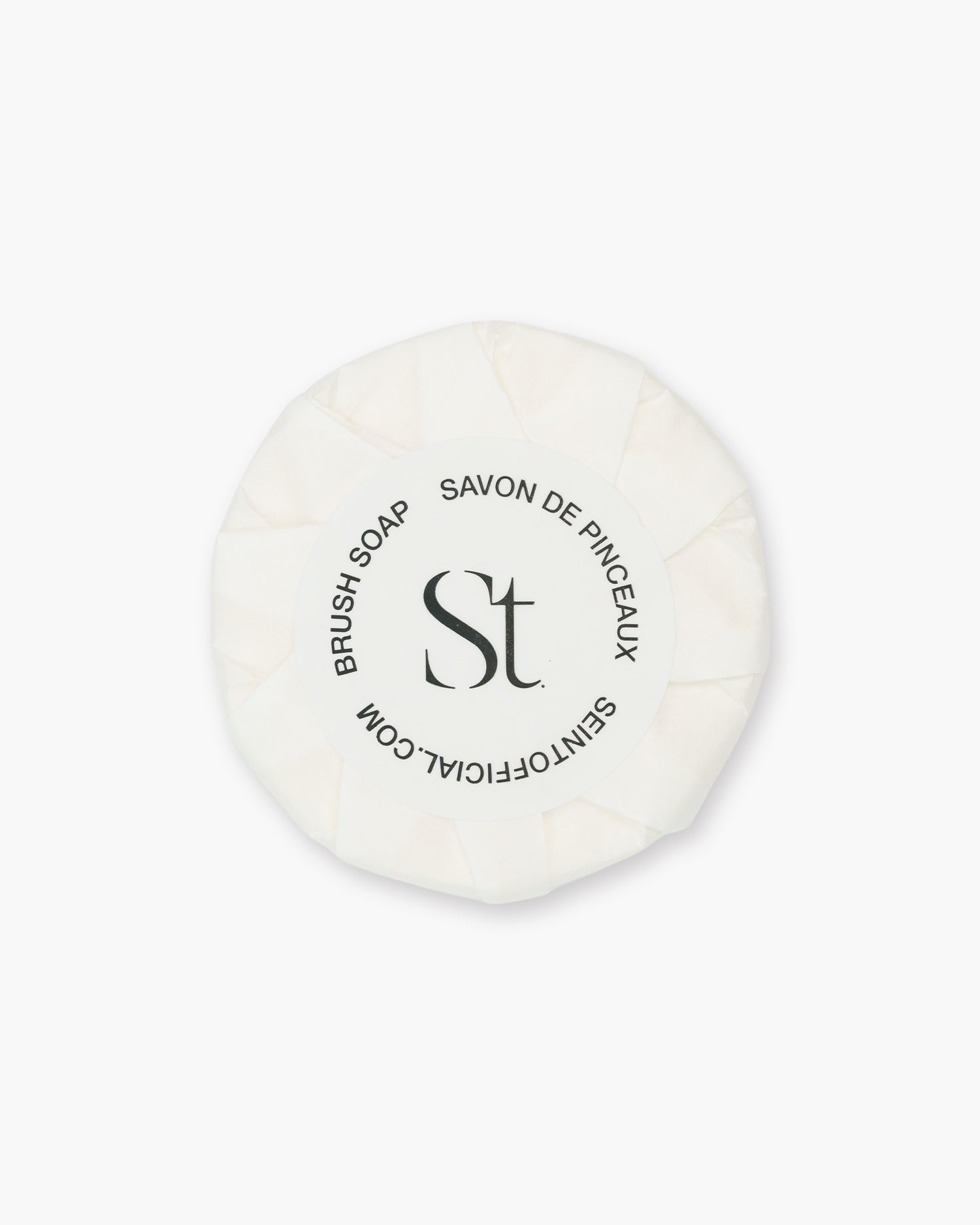 Seint Brush Cleansing Soap Refill: round bar pleat-wrapped in white paper with a circular brush soap label