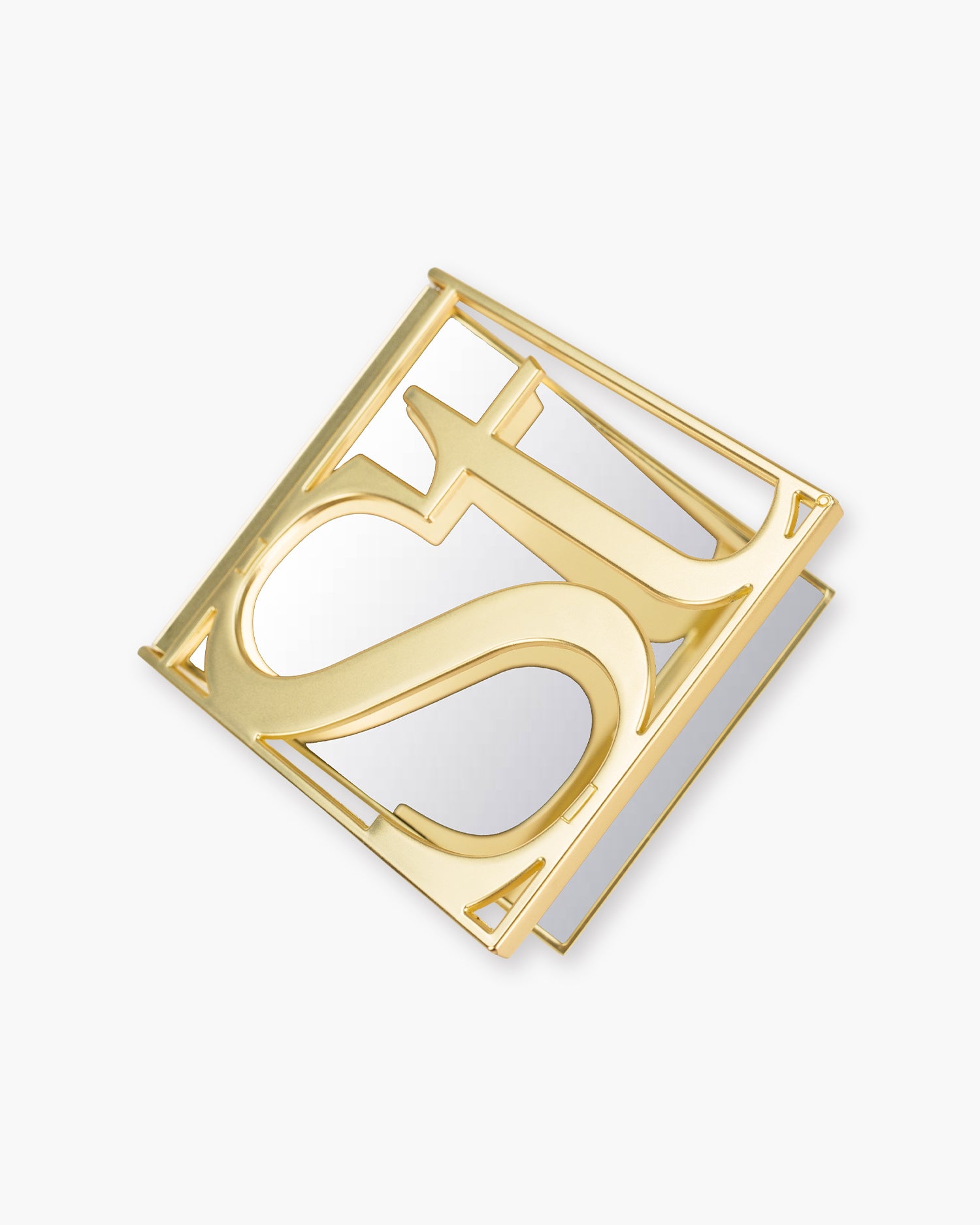 Seint Mercury Compact Mirror shown at an angle, gold serif monogram lid resting over the mirror base