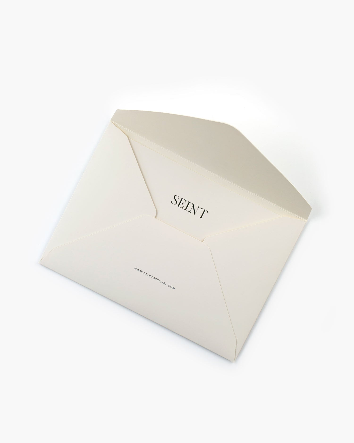 Seint Card + Envelope in Ivory, the open cream envelope showing SEINT and seintofficial.com printed inside