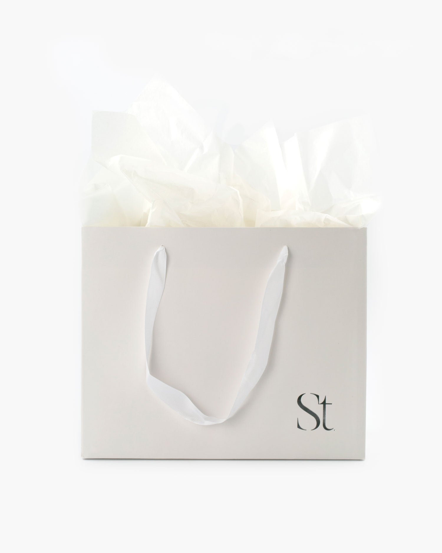 Seint Gift Bag + Tissue Paper — ivory bag with ribbon handles and white tissue puffed from the top
