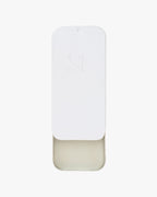 Seint Saved Salve white slide-top tin with embossed logo, lid partly open to reveal the clear conditioning balm